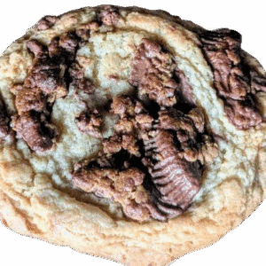 Close-up of a chocolate chip cookie with a partially embedded chocolate candy.